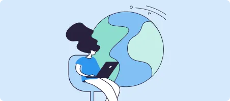 Woman sitting with laptop in front of a large globe, symbolizing global connectivity.